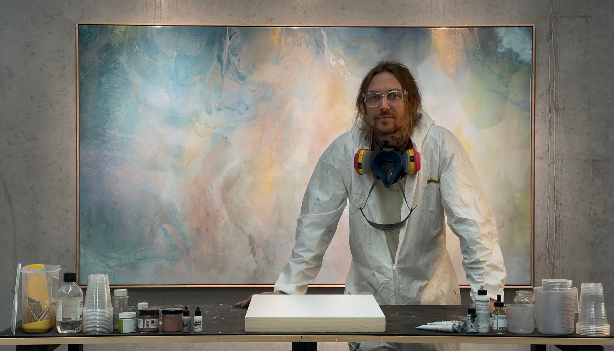 Mitch Gobel in his studio, standing before one of his large resin artworks.